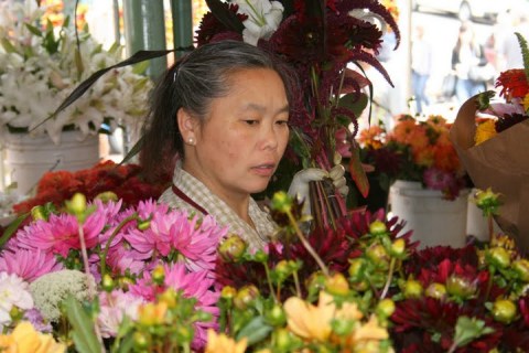 Flower vendor making up a bouquet