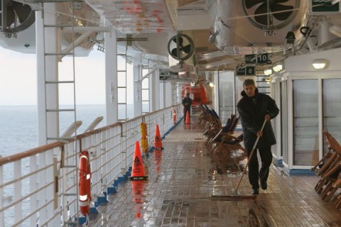 Crew swabbing the Promenade deck early in the morning