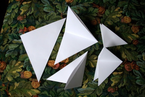 Fold each square in half to make a triangle.  Then fold in half again.  And again.