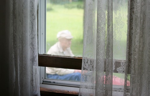 Looking through the living room window at my 94-year-old Dad mowing the lawn