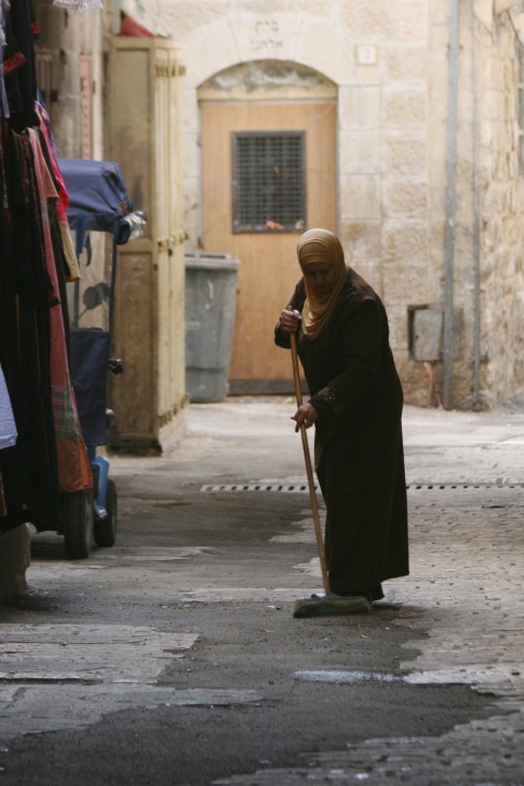 Shopkeeper sweeping in Old City, Jerusalem